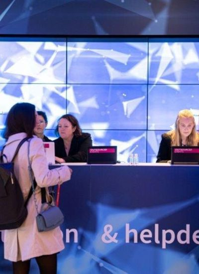 Delegates being helped at a registration and help desk