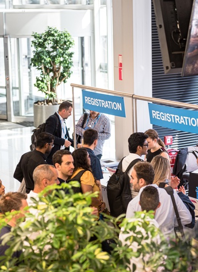 People queuing at registration desks