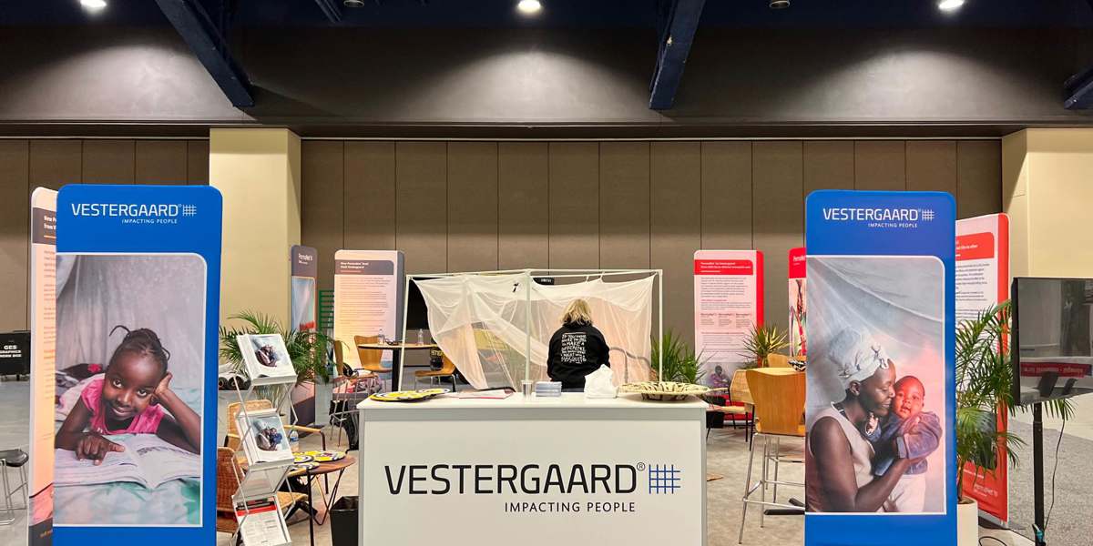 A tradeshow stand featuring the Vestergaard brand and mosquito nets