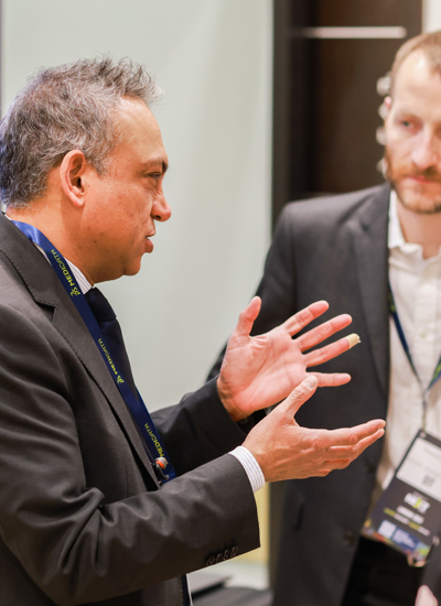 People talking at a tradeshow booth 