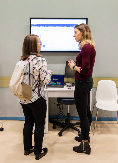 Two people standing in front of a tradeshow booth