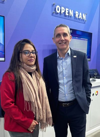 Two people standing in front of a tradeshow booth