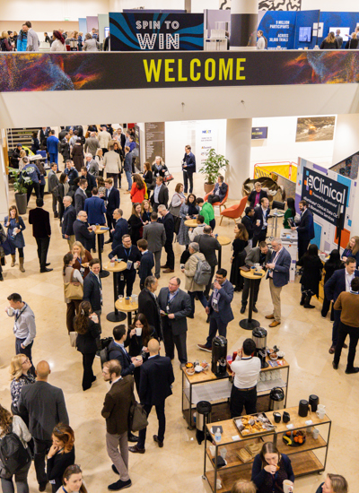 The entrance lobby of a conference centre with lots of people standing on two levels