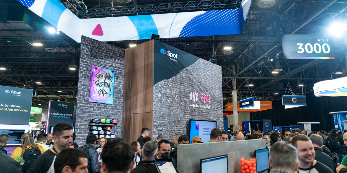 Group of people standing and conversing at a tradeshow booth