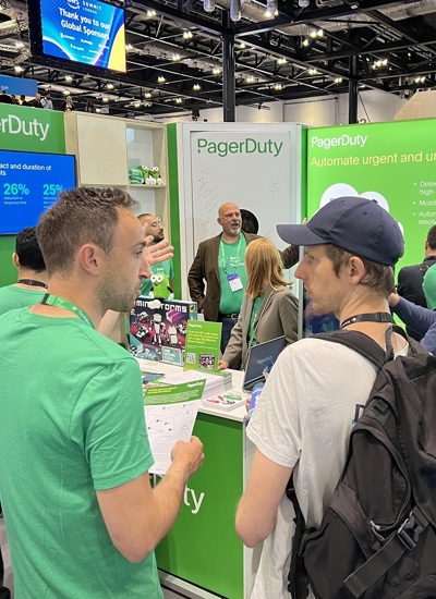 People talking at the PagerDuty tradeshow booth