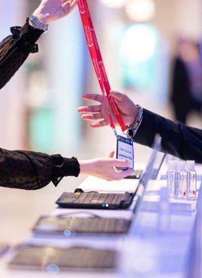 A delegate receiving their badge at registration